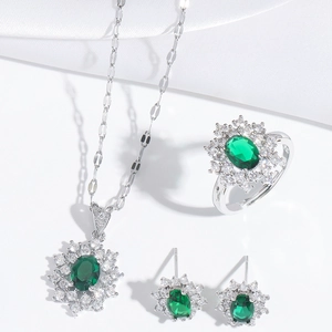 Detailed macro view of emerald green jewelry set with necklace, ring and earrings