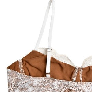 Detail of adjustable straps and floral lace overlay on a backless brown maxi dress