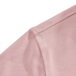Close-up of pink quick-dry fabric texture and precise stitching on the polo shirt shoulder