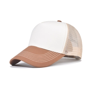 Detail of breathable mesh panel and curved brim on a two-tone trucker baseball cap