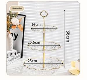Three-tier glass cake stand with golden metal handle and wavy gold rim edges