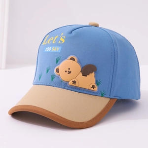 Detailed close-up of blue and khaki contrast baseball cap with cartoon bear silicone patch