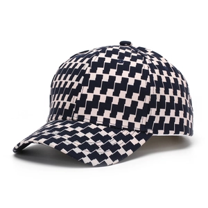 Detail of classic black and white plaid baseball cap with curved brim and 6-panel design