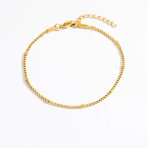 Detailed macro view of a 18k gold plated stainless steel box chain with lobster clasp