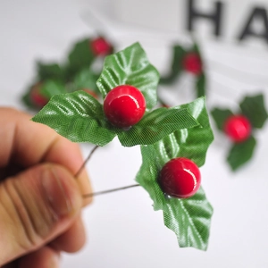 Artificial red berries with green leaves on wire stems for Christmas decoration
