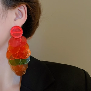 Macro shot of long layered earrings with colorful translucent resin shell discs