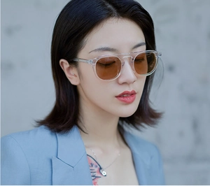 Fashionable round jelly frame sunglasses with brown lenses shown on a model portrait