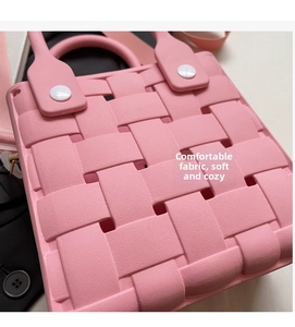 Detailed view of pink EVA woven handbag with textured wide straps and decorative buttons