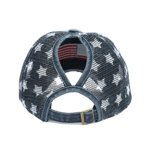 Detail of washed denim ponytail hat with white star patterns and metal buckle