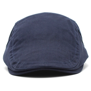 Detail of navy blue cotton flat cap showing reinforced stitching and twill fabric