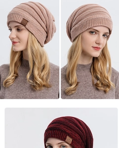 Detailed close-up of knit beanie texture and leather sport logo patch on the folded cuff