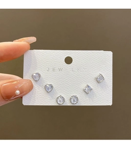Detailed view of 3-pair 925 silver post stud set with heart and geometric zircons