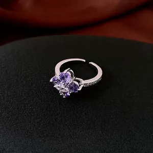 Adjustable silver flower ring with purple zircon crystals and sparkling petal design