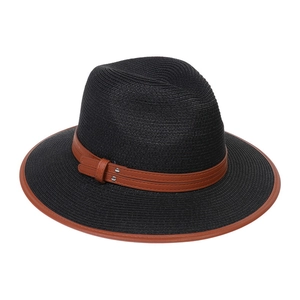 Detail of black straw hat featuring brown leather band trim and decorative metal studs