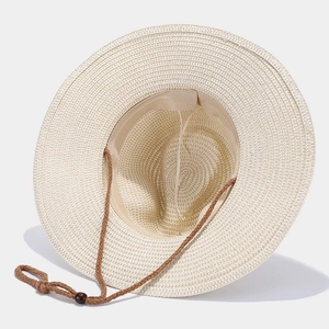 Close-up of woven straw hat with adjustable brown chin strap and wooden bead detailing