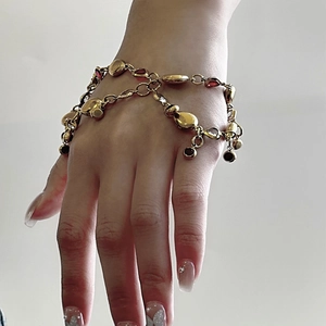 18K gold-plated titanium steel bracelet featuring a deep red gemstone and double-layered chain