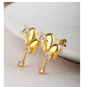 Detailed macro shot of 18K gold plated heart earrings with sparkling cubic zirconia crystals