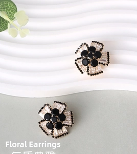 Elegant floral stud earrings featuring black center stones and white zircon petals in gold