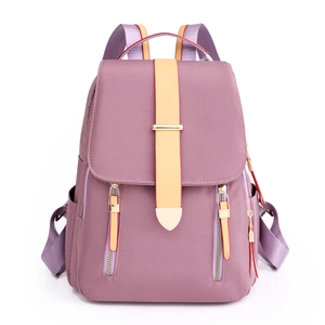 Waterproof purple nylon backpack with yellow strap and front zippers for travel