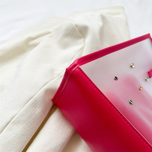Transparent tote bag with rose red leather and colorful rhinestones in a detailed view