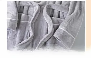 Close-up of plush light gray flannel bathrobe with reinforced stitching and soft tie belt
