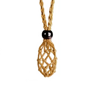 Detail of adjustable woven rope necklace pouch with decorative black bead in natural tan