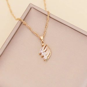Golden feather necklace with white cubic zirconia crystals on a water-wave chain