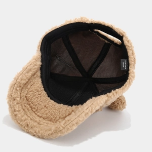 Internal detail of a camel fleece baseball cap showing lining and 57-58cm size label