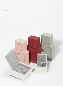 Velvet jewelry boxes in various colors showing storage for rings, earrings and necklaces