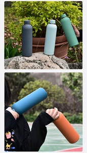 Outdoor close-up of colorful 750ML matte stainless steel vacuum flasks on rocks