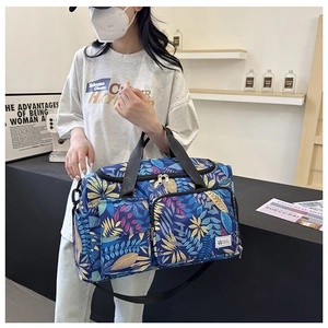 Travel tote bag featuring leaf prints, functional pockets, and large capacity for sports