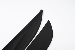 Close-up of the black halter dress back strap and high-quality woven fabric detail