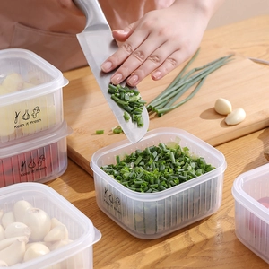 Transparent food storage box with lid for fresh ginger and garlic in the kitchen