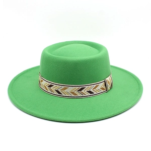 Detail of bright green wool felt boater hat with geometric patterned jacquard band