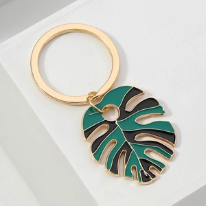 DIY Monstera leaf keychain with green and black enamel inlay on gold-plated metal