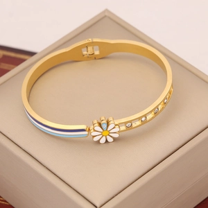 Elegant gold stainless steel bangle with enamel daisy flower and rhinestone inlay