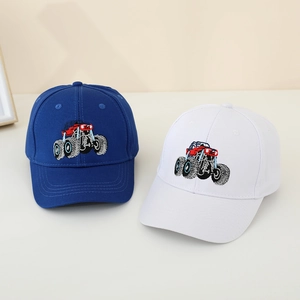 Detail shot of embroidered off-road truck patterns on cotton baseball caps for boys