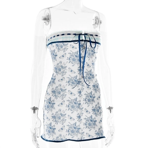 Detailed view of floral tube dress featuring lace trim and a delicate blue ribbon bow