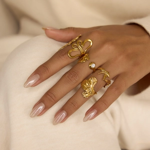 Set of four 18K gold plated stainless steel rings featuring bird and ginkgo leaf designs