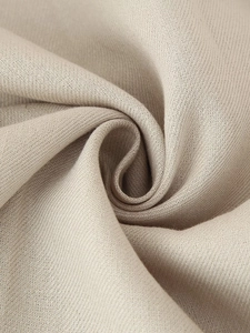 Close-up macro view of the khaki beige fabric showing detailed twill texture and fiber
