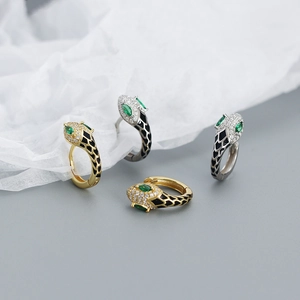 Snake hoop earrings in gold and silver finish with black enamel and green gemstone eyes