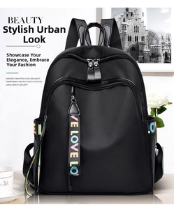 Detail of black waterproof Oxford backpack featuring a colorful LOVE letter ribbon pendant