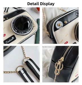 Detail of camera-shaped PU crossbody bag featuring striped strap and fashion prints