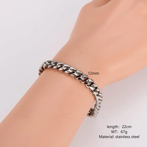 Detailed view of 12mm silver stainless steel Cuban link chain bracelet on wrist