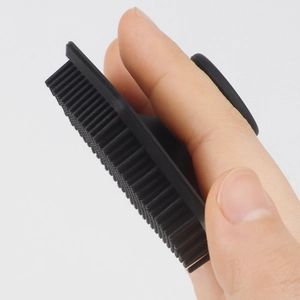 Black silicone facial cleansing brush with finger loop for gentle pore exfoliating massage