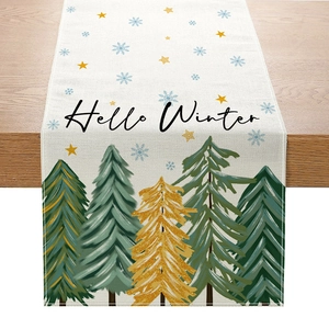 Christmas table runner with Hello Winter print and festive green gold trees on wood surface