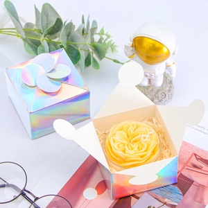 Detailed holographic gift box with floral candle and decorative petal lid closure