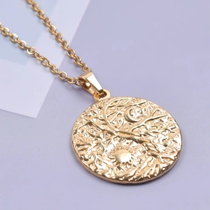 Macro shot of 18K gold plated stainless steel tree of life pendant on O-chain necklace