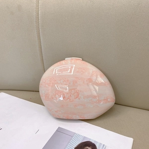 Pink marble texture egg-shaped evening clutch bag with glossy finish and crossbody strap