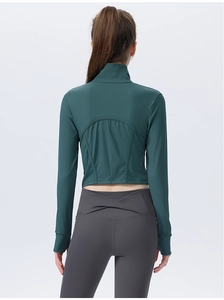 Detail view of the ribbed texture and seamless stitching on the green crop yoga jacket